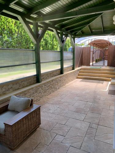 a pavilion with a bench and stairs on a patio at The Jakuzzi Room Miskolctapolca in Miskolc