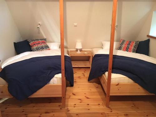 two twin beds in a room with two posts at Ferienhaus im Bauerngarten in Hoyerhagen