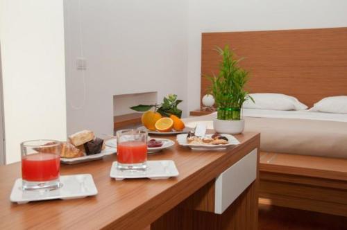 a table topped with a tray of food on top of a bed at Hotel La Dimora di Piazza Carmine in Ragusa