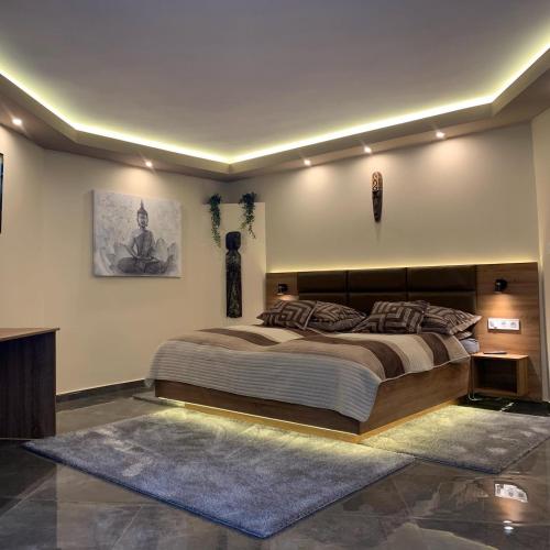 a bedroom with a large bed in a room at The Jakuzzi Room Miskolctapolca in Miskolc