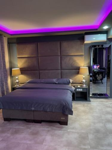 a bedroom with a large bed with purple lighting at New York Pension in Dunajská Streda