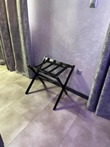 a chair sitting in a corner of a room at New York Pension in Dunajská Streda