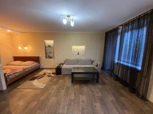 a bedroom with two beds and a table in it at Welcome Apartments in Dnipro