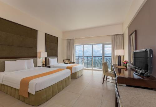 Postel nebo postele na pokoji v ubytování Taal Vista Hotel