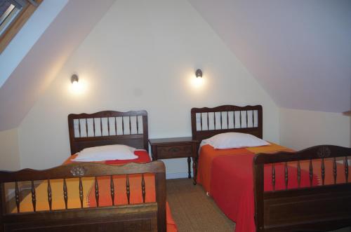 two twin beds in a room with two tables at Gîtes du Manoir de Goandour in Crozon