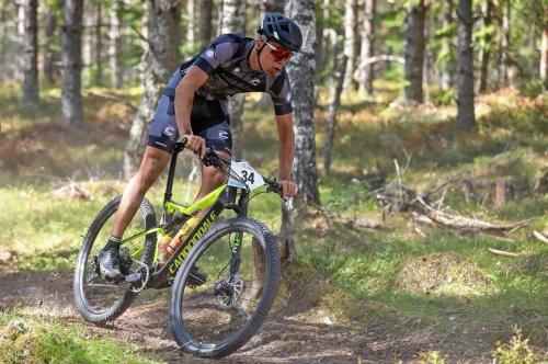 a man riding a bike on a trail in the woods at Hotel Statt Söderhamn by First Hotels in Söderhamn