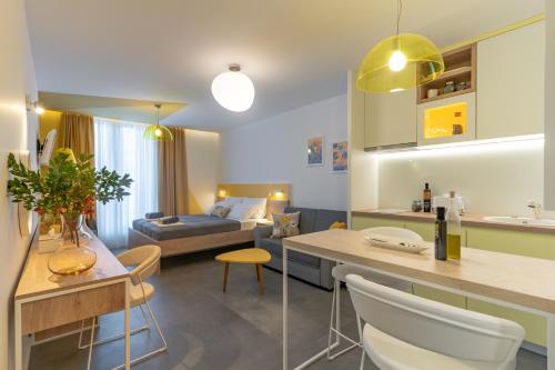 a living room with a kitchen and a bedroom at Apartments Olea in Cavtat