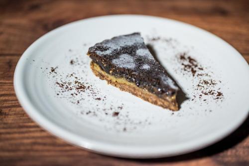 a piece of cake on a plate on a table at Monte Gois Country House e Spa in Curvatos