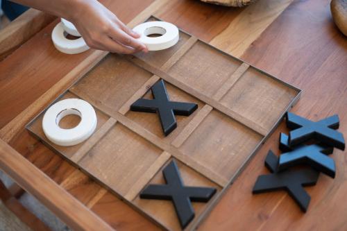 a person playing a board game on a table at Monte Gois Country House e Spa in Curvatos