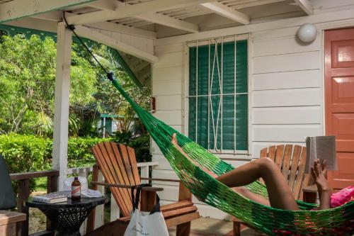 a woman laying in a hammock on a porch at Samsara Cliff Resort in Negril