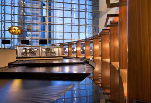 a hallway with a table and chairs in a building at Hyatt Regency Dallas in Dallas