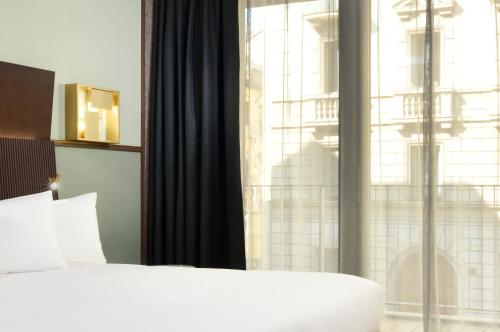 a bedroom with a bed and a large window at Milano Verticale | UNA Esperienze in Milan