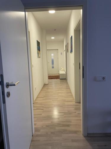 an empty hallway with a hallway leading to a room at Ferienwohnungen AKH Home in Sankt Wendel