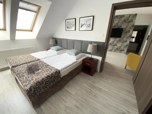 a bedroom with a large bed and a mirror at Hotel Srebrna Góra in Srebrna Góra
