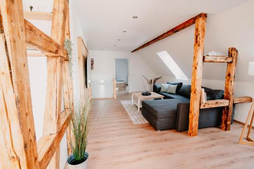 a living room with a loft bed and a couch at WohnWerk Ferienwohnungen Lautenthal in Langelsheim