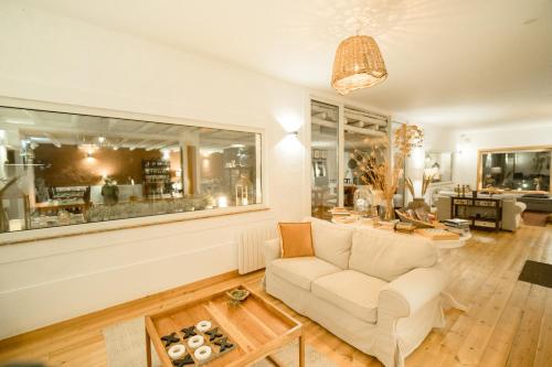 a living room with a couch and a table at Monte Gois Country House e Spa in Curvatos