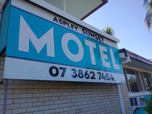 a sign for a motel on the side of a building at Aspley Sunset Motel in Brisbane