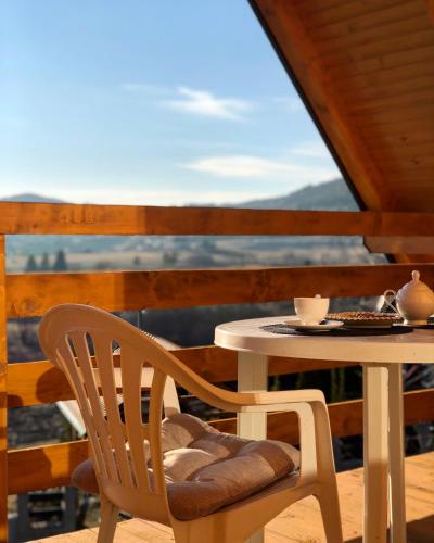 a table and chair sitting on a porch with a table and a table at Casa Mia Resort in Kupres