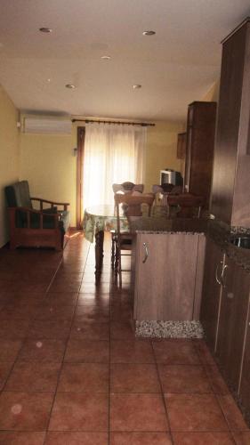 a kitchen with a counter and a table in a room at Apartaments la Fabrica in Horta de San Joan