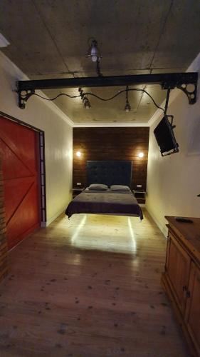 a bedroom with a bed and a television in a room at Лофт с гамаком с видом моря в 9 Жемчужине в Аркадии, Кадор in Odesa