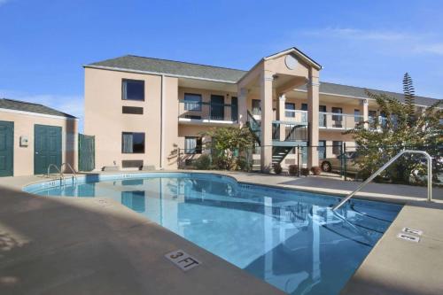 a swimming pool in front of a apartment building at Days Inn By Wyndham Lexington-Columbia in Lexington