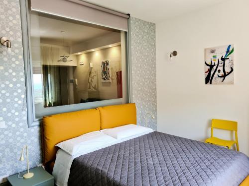 a bedroom with a bed with a mirror above it at Casa Battisti in Agrigento
