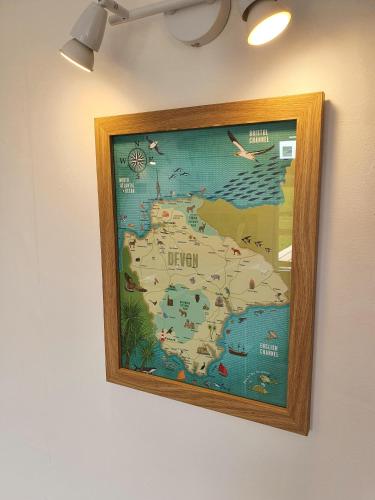 a framed map of ireland hanging on a wall at Dartmoor Reach Alpaca Farm Heated Cabins 5 mins drive to Dartmoor in Bovey Tracey