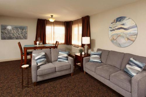 a living room with two couches and a table at Quality Inn Oakwood in Spokane