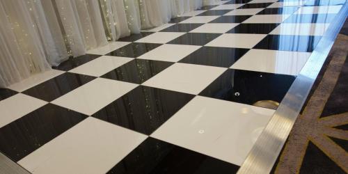a black and white checkered floor with a glass table at Crowne Plaza Aberdeen Airport by IHG in Dyce