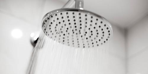 a shower head with white hair hanging from it at Crowne Plaza Aberdeen Airport by IHG in Dyce