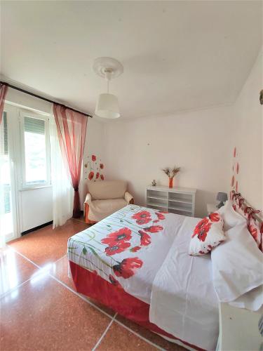 a bedroom with a large bed and a couch at il Papavero in Recco