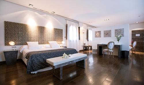 a hotel room with a bed and a desk at Hospes Palacio del Bailio, a Member of Design Hotels in Córdoba