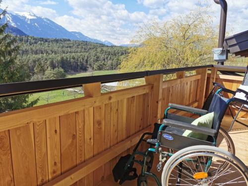 a wheelchair on a deck with a view of the mountains at Zauscherhof in Wildermieming
