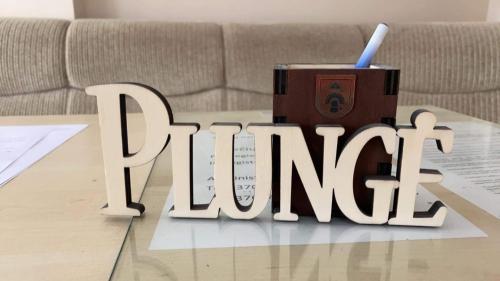 a wooden sign that says living on a table at Babilonas in Plungė