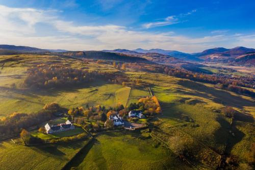 an aerial view of a house on a green field at Errichel House and Cottages in Aberfeldy