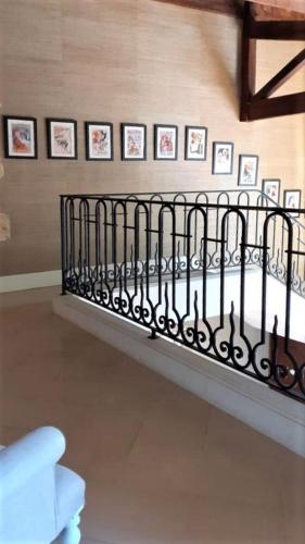 a wall with pictures on a wall with a fence at Manoir du Bois Mignon in Le Fleix