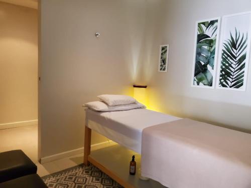 a bedroom with a white bed with a bottle on it at Villa Isidro Hotel Boutique & Spa in San Isidro