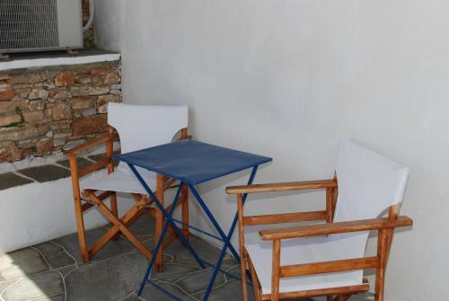 two chairs and a blue table and two chairs at Windmill Villas in Artemonas