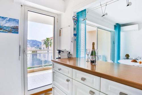 La salle de bains est pourvue d'un comptoir avec un lavabo et un miroir. dans l'établissement Bright One BDRM Apartment A/C-Swimming Pool/Congress by Olidesi, à Cannes