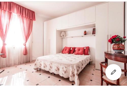 a bedroom with a bed with red pillows on it at Riva dei fiori in Viareggio