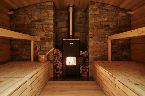 a room with a wood stove in a building at Goldene Rose Karthaus a member of Small Luxury Hotels of the World in Senales