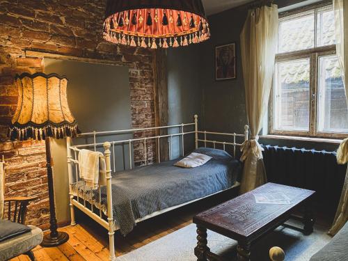 a bedroom with a bed and a brick wall at Baznīcas ielas apartamenti in Kuldīga