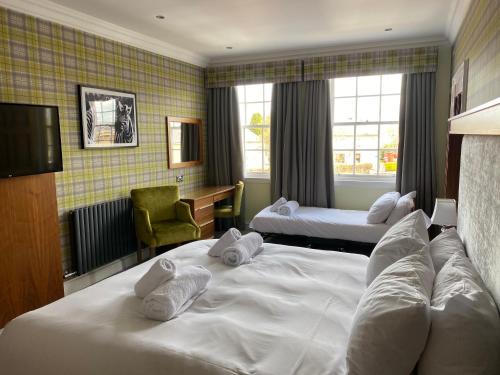 A bed or beds in a room at The Craigie Hotel