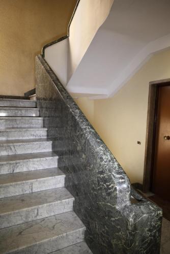 a set of stairs in an old building with a marble stair case at Eletta Guest House in Rome