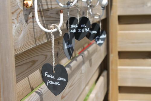 a bunch of hearts hanging on a wooden door at Les bains de mer in Saint-Quay-Portrieux