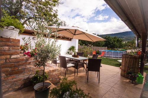 a patio with a table and an umbrella at Penzion Marhulka in Dolní Věstonice