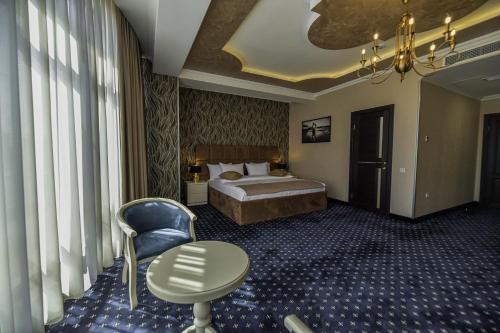a hotel room with a bed and a table and a chair at Welcome Inn Hotel in Yerevan
