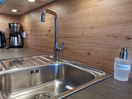 a kitchen sink with a soap bottle next to it at Zauscherhof in Wildermieming