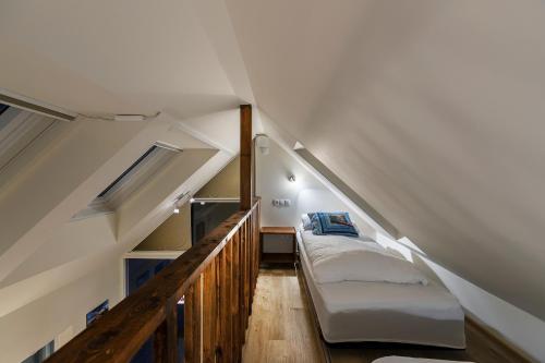 a small bedroom with a bed in the attic at Hlid Fisherman's Village in Álftanes
