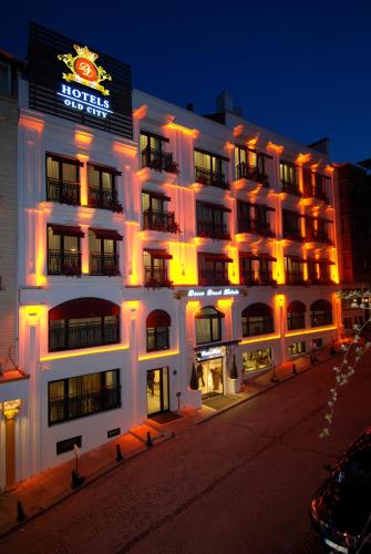 a large white building with a neon sign on it at Dosso Dossi Hotels Old City in Istanbul